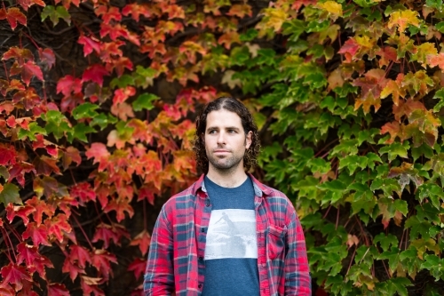 Man in front of changing autumn leaves - Australian Stock Image