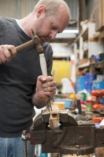 Man learning woodwork in the shed - Australian Stock Image