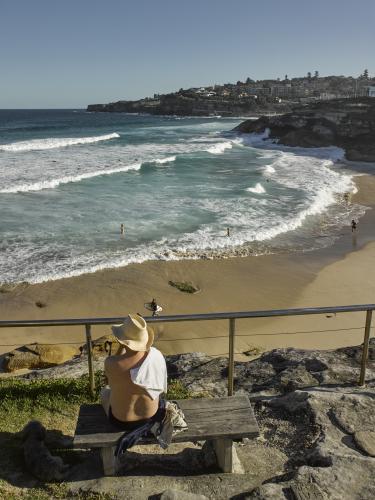man looking out over Tamarama Beach - Australian Stock Image