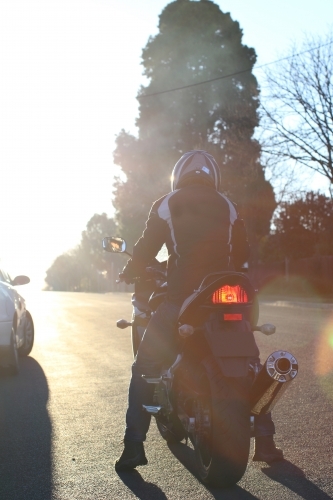 Man riding motorbike on a suburban street