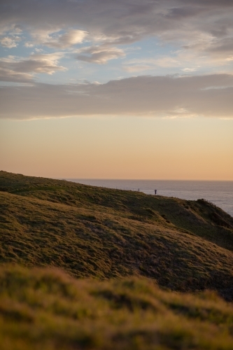 Man standing on hillside - Australian Stock Image