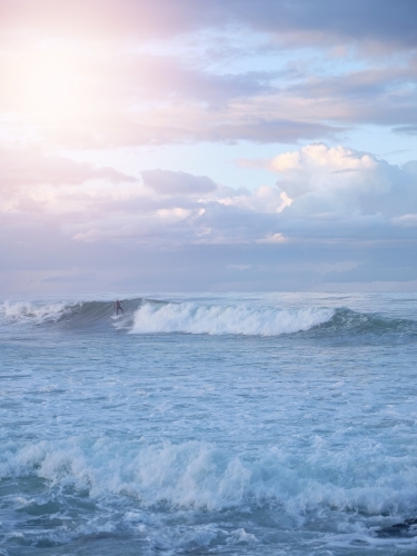 Man surfing over big waves on the beach - Australian Stock Image