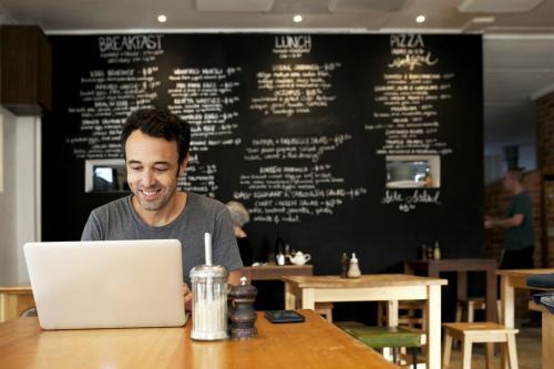 Man with laptop at a cafe - Australian Stock Image