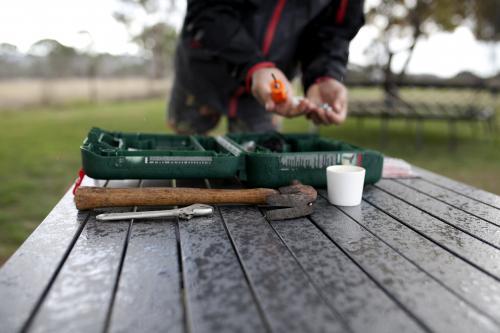 Man with toolkit and tools in foreground - Australian Stock Image
