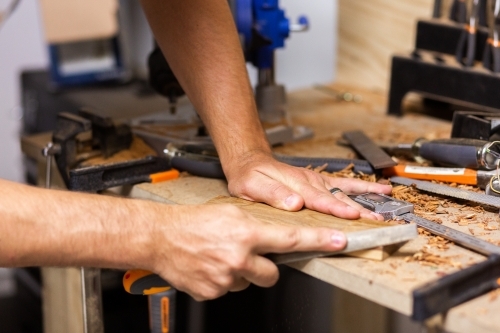 Man working in shed filling woodwork project - Australian Stock Image