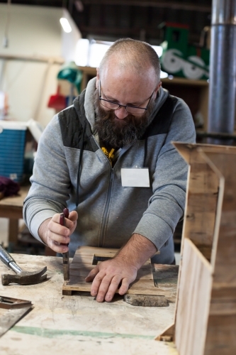 Man working on a project in a men's shed - Australian Stock Image