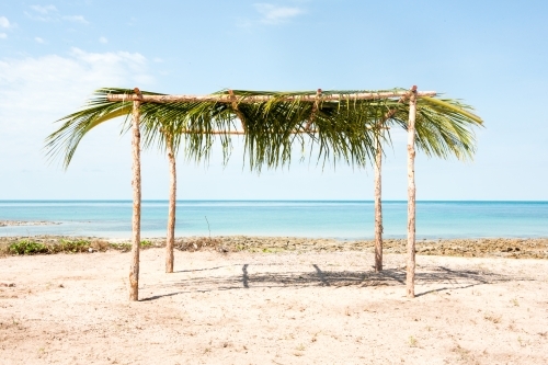 Manmade leafy structure on a beach - Australian Stock Image