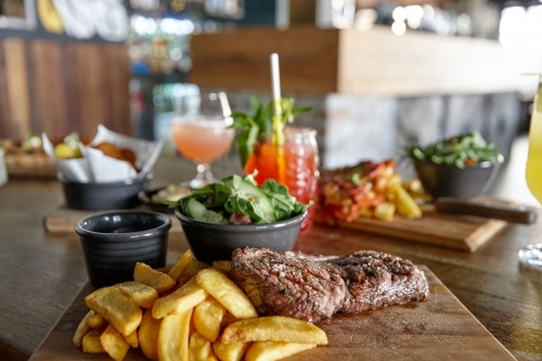 Meal of meat and chips on table - Australian Stock Image