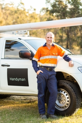 Middle age man and his ute happy to be working for himself as handyman - Australian Stock Image