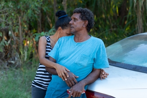 middle-aged couple leaning on car boot - Australian Stock Image