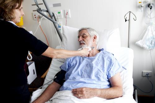 Middle aged male patient being treated by a nurse in a hospital ward