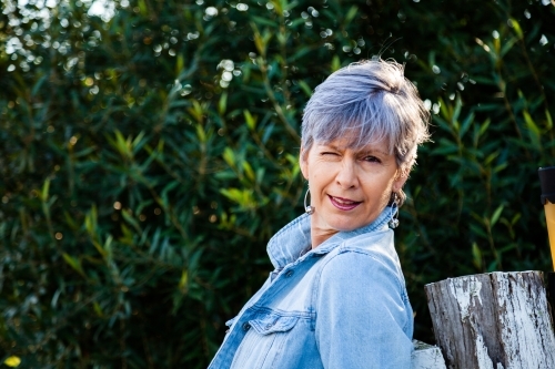 Middle aged woman winking and pulling fun faces - Australian Stock Image