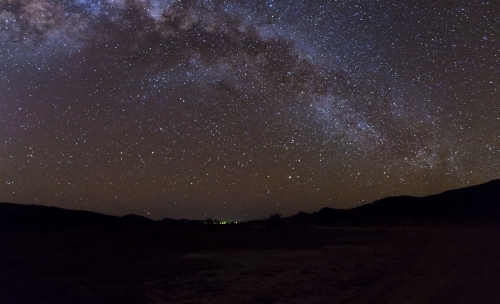 Milky Way arching over remote landscape - Australian Stock Image