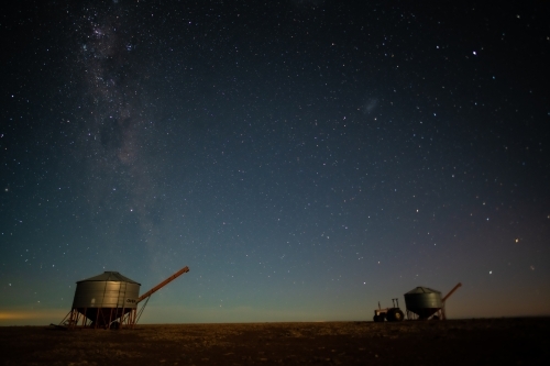 Milky Way setting behind two farming containers in the Australian night sky. - Australian Stock Image