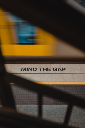 Mind the gap messaging on a train platform in Sydney - Australian Stock Image
