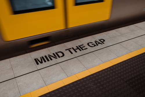 Mind the gap messaging on a train platform in Sydney - Australian Stock Image