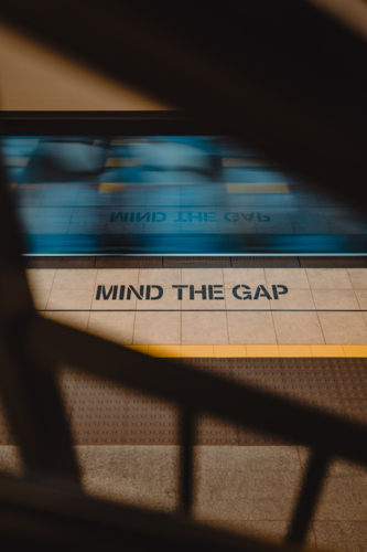 Mind the gap messaging on a train platform in Sydney - Australian Stock Image