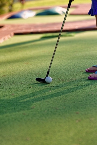 Mini golf or putt-putt green with iron and ball for children - Australian Stock Image