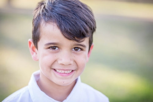 Mixed race aboriginal and caucasian boy smiling - Australian Stock Image