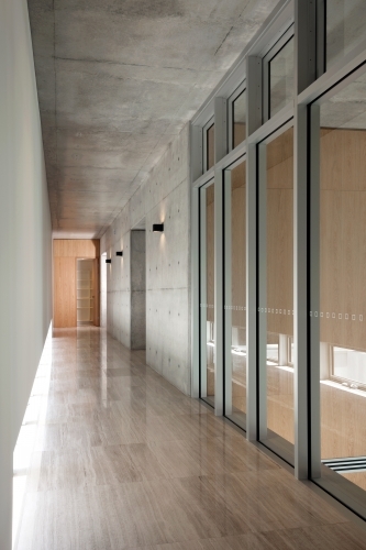 Modern hallway with floorboards and glass doors - Australian Stock Image