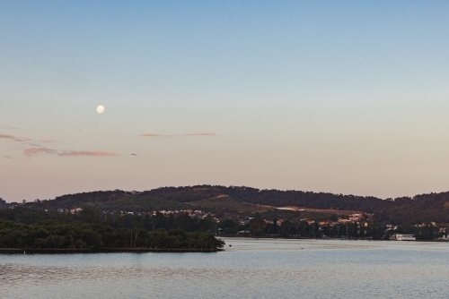 Moon rising over Lake Macquarie, NSW - Australian Stock Image