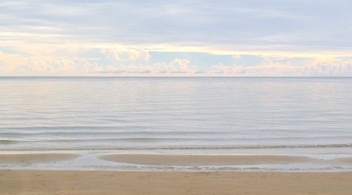 morning light reflecting off magnificent clouds and calm waters - Australian Stock Image