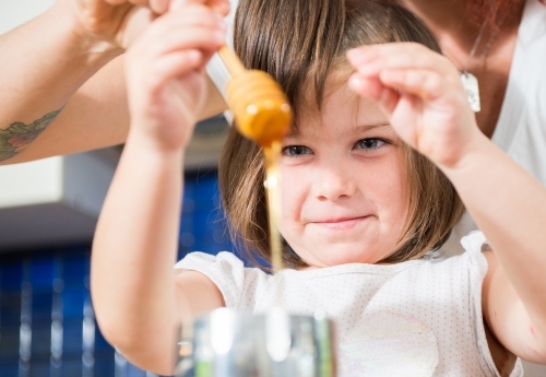 Mother and daughter cooking at home - Australian Stock Image