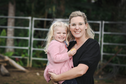 Mother and daughter sharing affectionate moment in the garden - Australian Stock Image