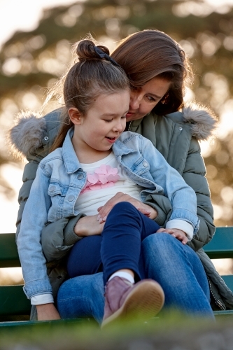 Mother and daughter sharing time at park - Australian Stock Image