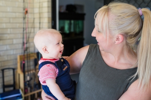 Mother and son looking at each other laughing - Australian Stock Image