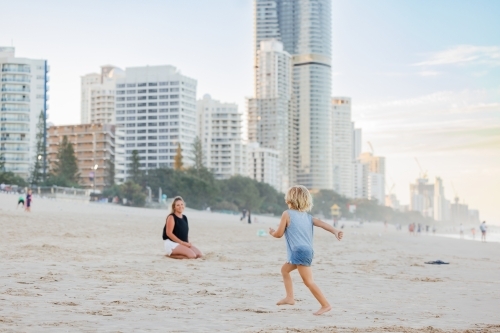 Mother and son playing on Main Beach at Surfers Paradise on the Gold Coast - Australian Stock Image