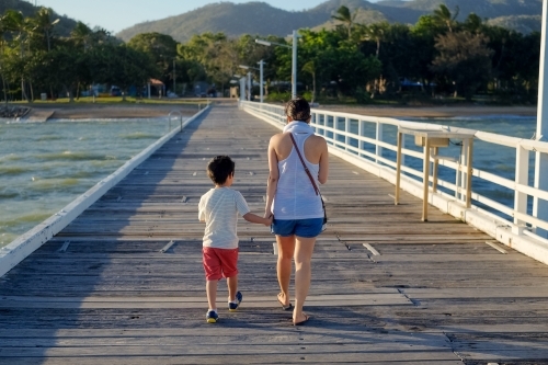 Mother and son walking down the jetty - Australian Stock Image