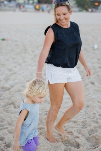 Mother and son walking on the beach at Surfers Paradise on the Gold Coast - Australian Stock Image