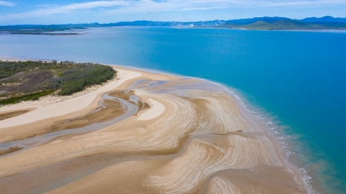 multicolour patterns at low tide on sands flats at The Point near Bird Island, Queensland - Australian Stock Image