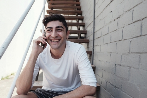 multicultural young adult man on the phone - Australian Stock Image