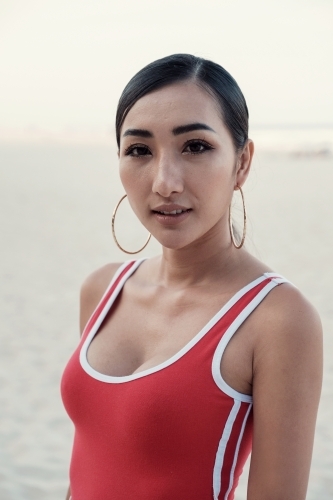 Multicultural young adult woman on the beach - Australian Stock Image