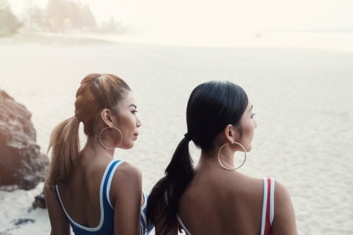 Multicultural young adult women on the beach - Australian Stock Image