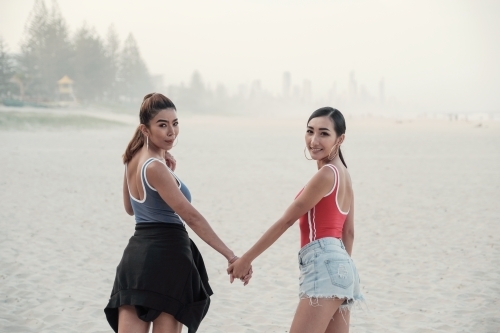 Multicultural young adult women on the beach - Australian Stock Image