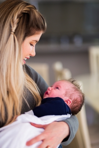 Mum smiling at baby boy - Australian Stock Image