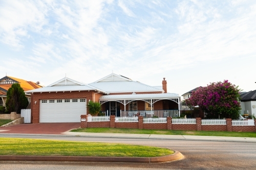 Neat road and house with large garage in coastal area - Australian Stock Image