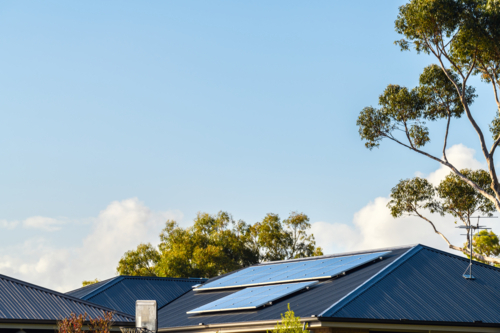 New solar panels installed on metal sheet roof of the house in South Australia - Australian Stock Image