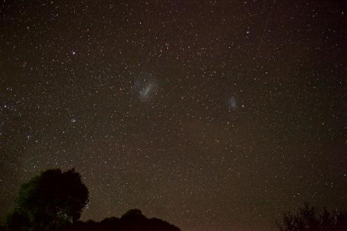 Night sky with stars and the large and small magellanic cloud galaxies - Australian Stock Image