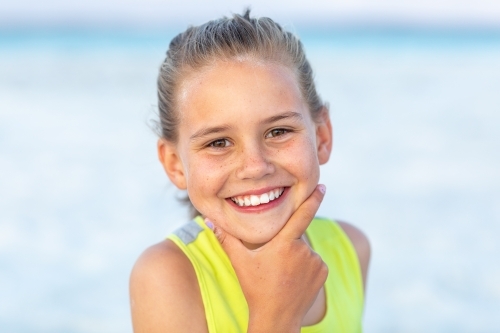 nine-year-old girl head and shoulders with hand on chin - Australian Stock Image