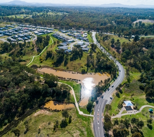 Nowlan park with Gardner circuit road going through it and a large dam in the waterway - Australian Stock Image