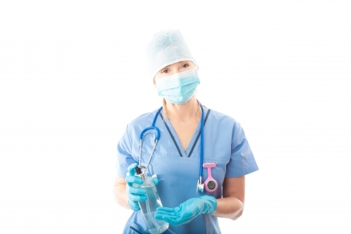 Nurse or doctor holding showing bottle of alcohol hand sanitizer to stop infection of virus pathogen