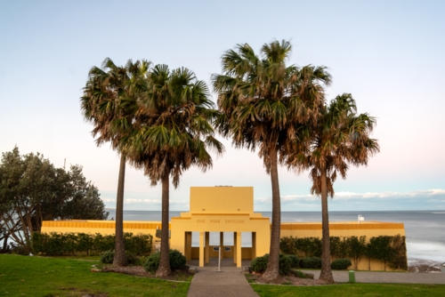 Oak Park Pavillion in Cronulla with palm trees at sunset - Australian Stock Image