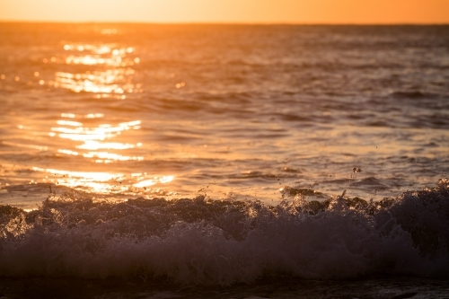 ocean and waves at sunrise - Australian Stock Image