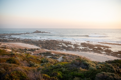 Ocean view of rugged coastline at sunset