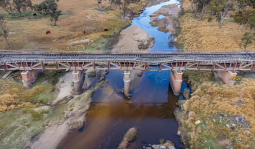 Old country railway bridge over a creek - Australian Stock Image