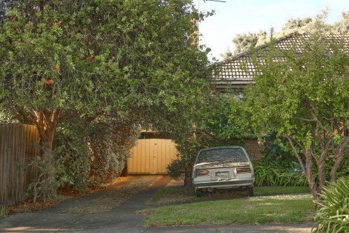 Old derelict care in suburban yard - Australian Stock Image